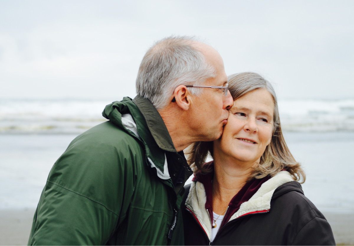 a man kissing a woman on the cheek