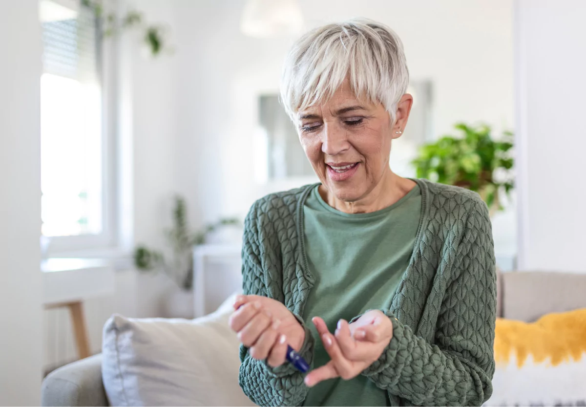 an elderly woman testing her blood