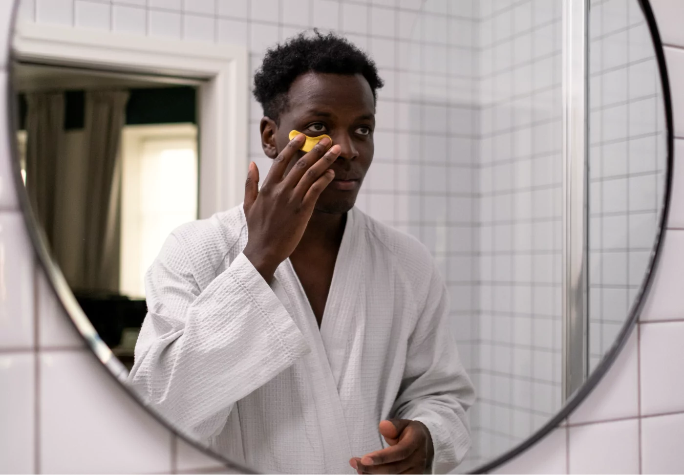 a man putting on eye cream