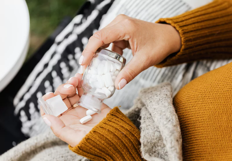 someone with a bottle of iron supplements