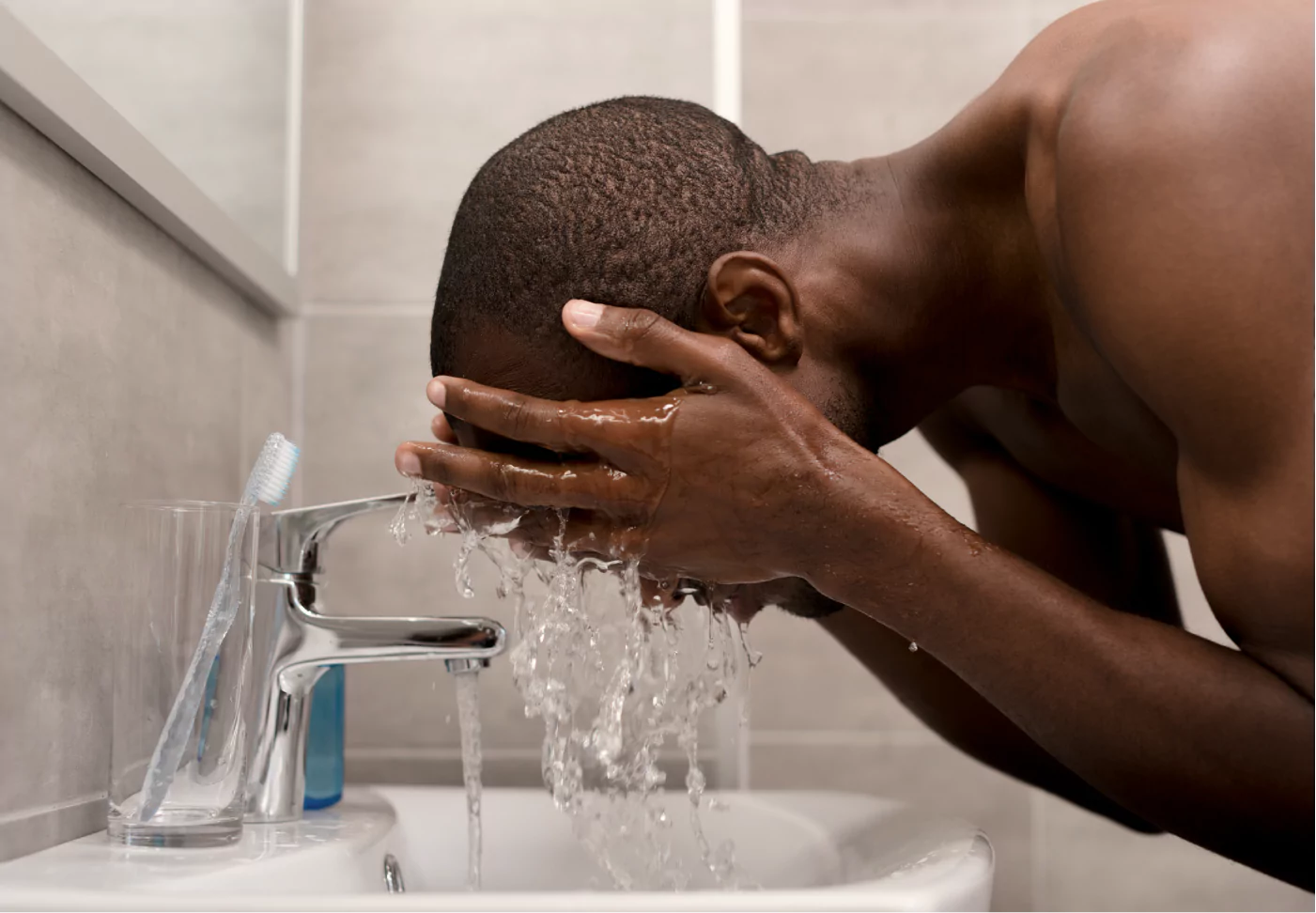 a man washing his face with water