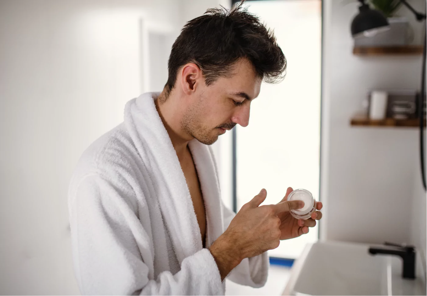 a man putting on sunscreen