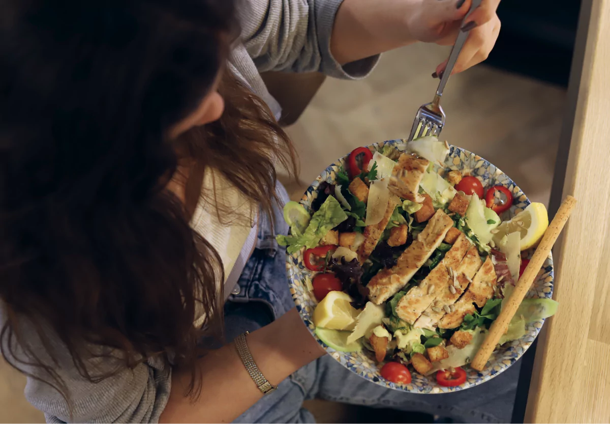 a woman eating a salad