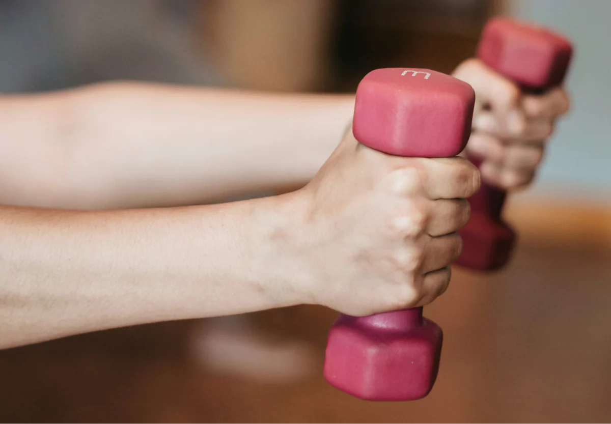 a girl holding dumbbells